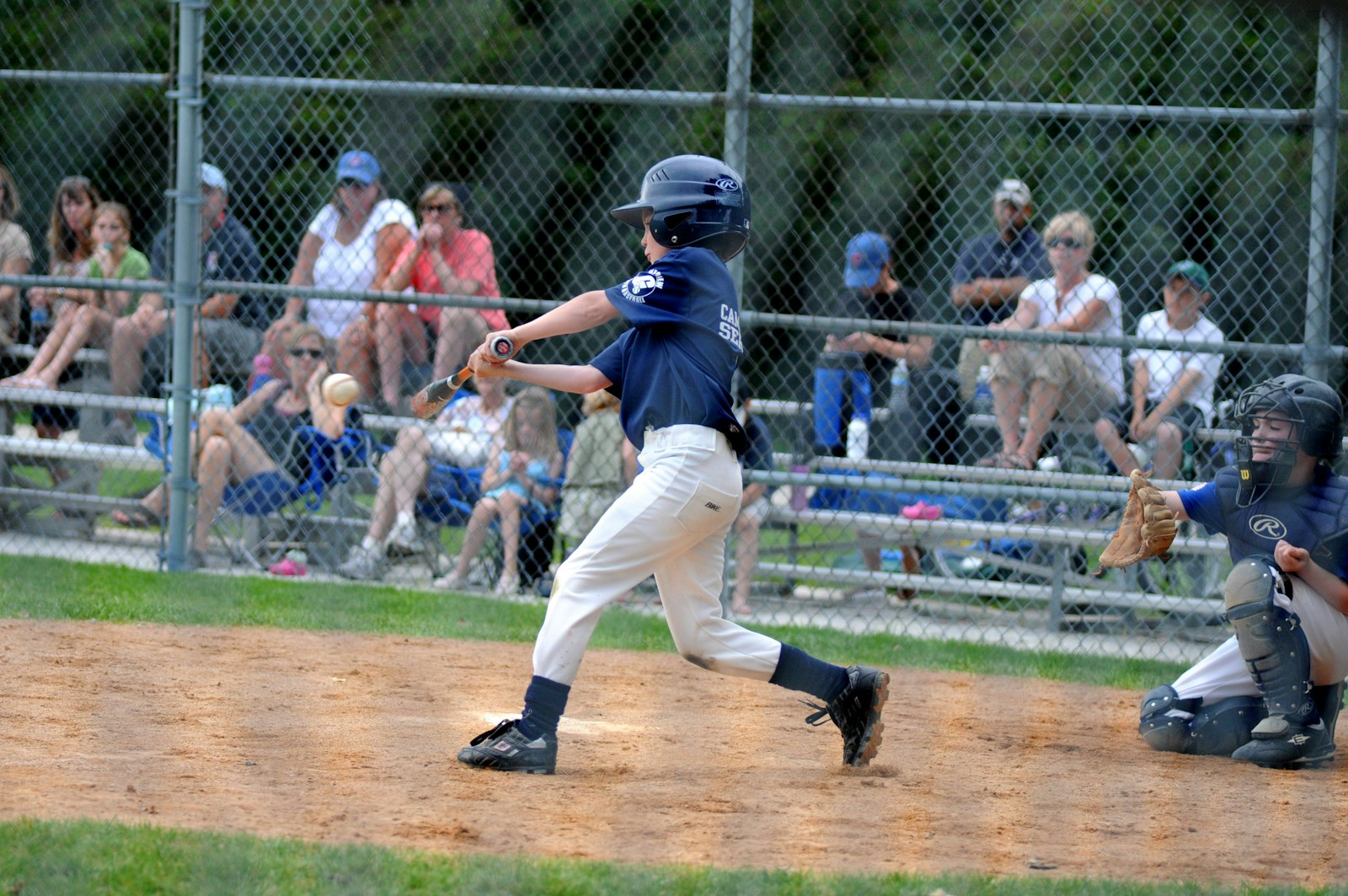 Youth baseball player batting during a little league game — photo by Unsplash